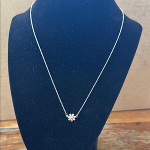 Silver daisy necklace.